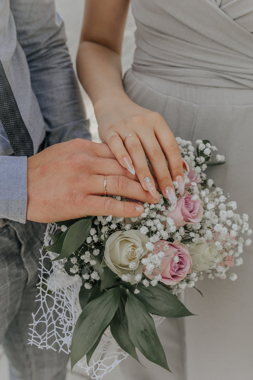 close up photo of bride and groom s hands