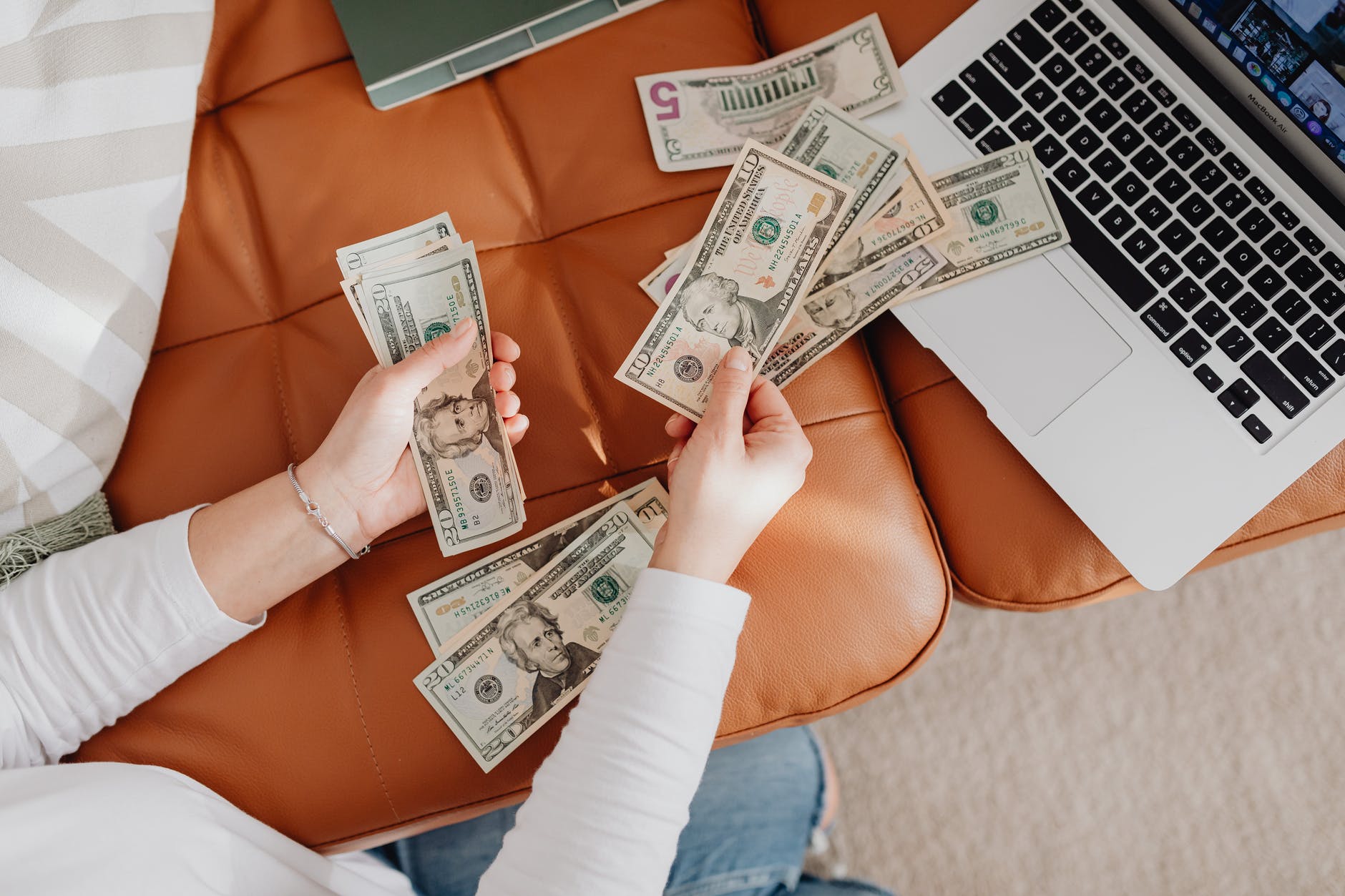 close up of woman counting dollar bills